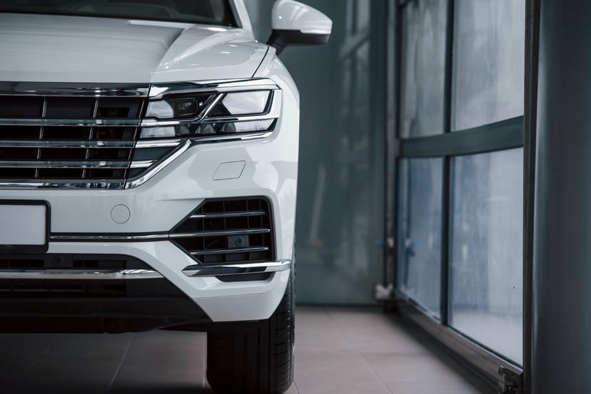 Editors%2 Fimages%2 F1645673833490 Bright Color Particle View Modern Luxury White Car Parked Indoors Daytime