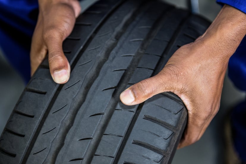 Editors%2 Fimages%2 F1648456177073 Hands Mechanic Holding Tyre