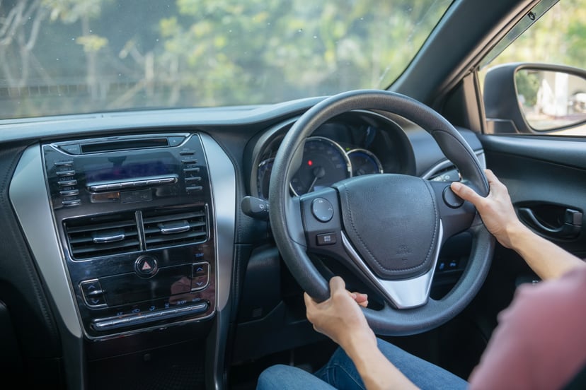 Editors%2 Fimages%2 F1657013622076 Confident Beautiful Rear View Attractive Young Woman Casual Wear Looking Her Shoulder While Driving Car Girl Holding Hand Wheel Handle Car Safety Concept