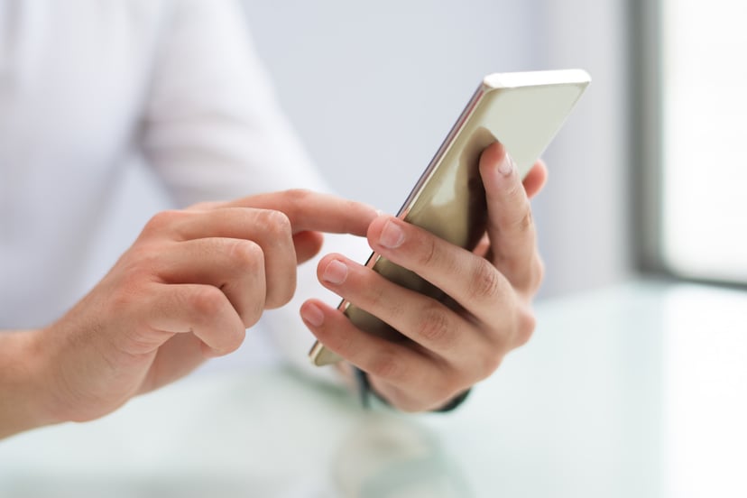 Editors%2 Fimages%2 F1657597679258 Close Up Male Hands Using Smartphone