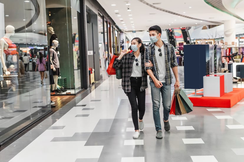 Young Couple Protection Mask Holding Multiple Paper Shopping Bag Walking Corridor Large Shopping Mall