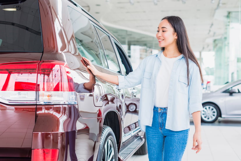 Editors%2 Fimages%2 F1673939073192 Happy Woman Car Dealership