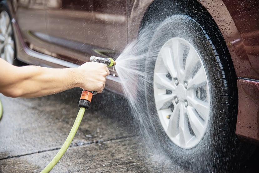 Man Washing Car Using Shampoo Water