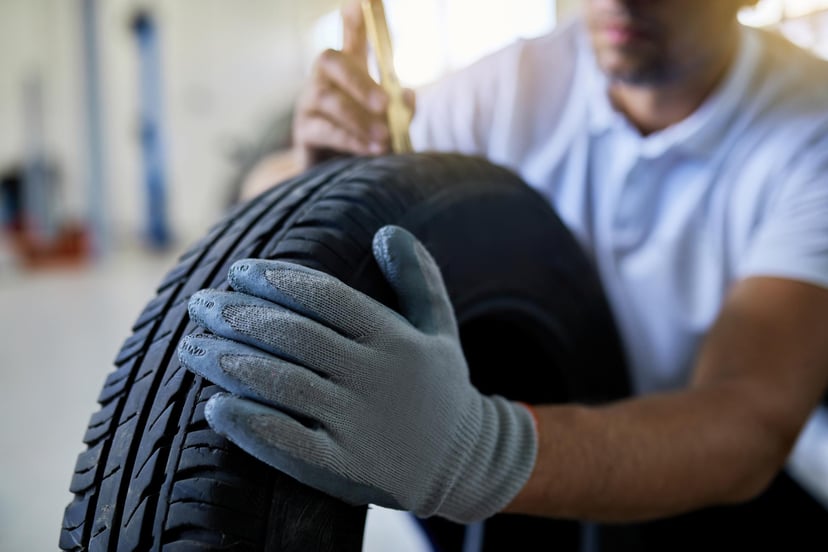Closeup Auto Repairman Measuring Depth Car Tire Auto Repair Shop