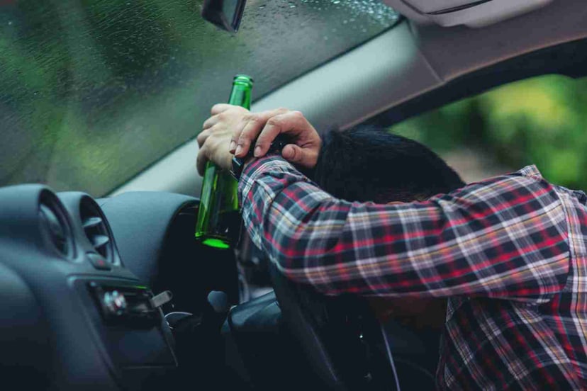Editors%2 Fimages%2 F1699516928161 Asian Man Holds Beer Bottle While Is Driving Car