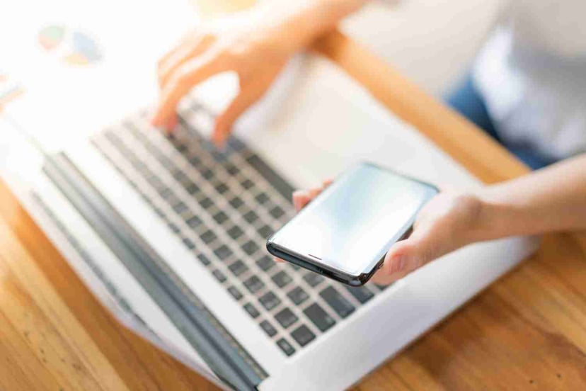 Business Woman Hand With Financial Charts Mobile Phone Laptop Table