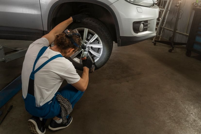 Male Mechanic Working Shop Car