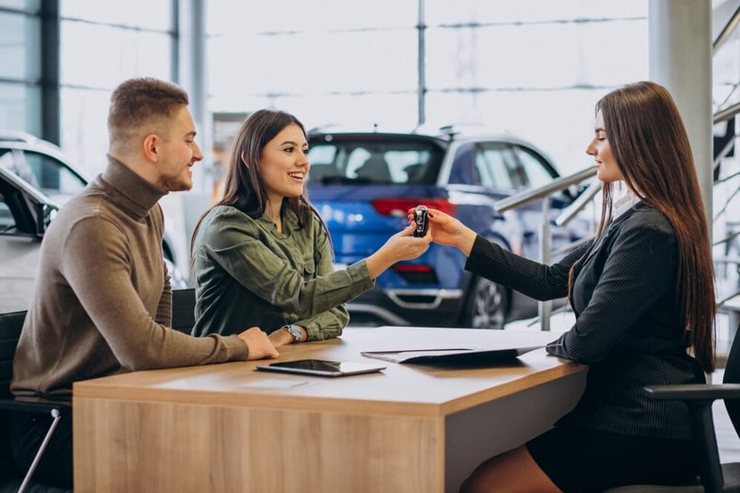 Young Couple Talking Sales Person Car Showroom 1303