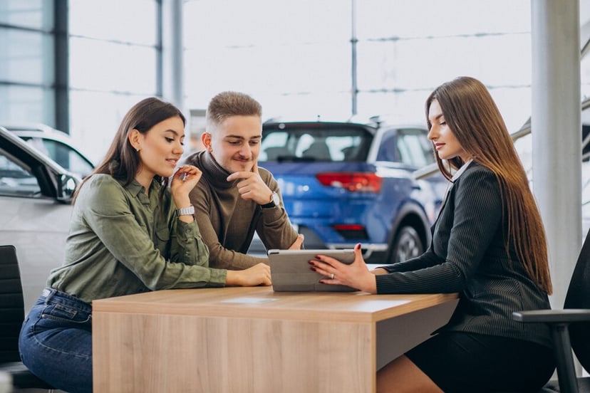 Young Couple Talking Sales Person Car Showroom 1303